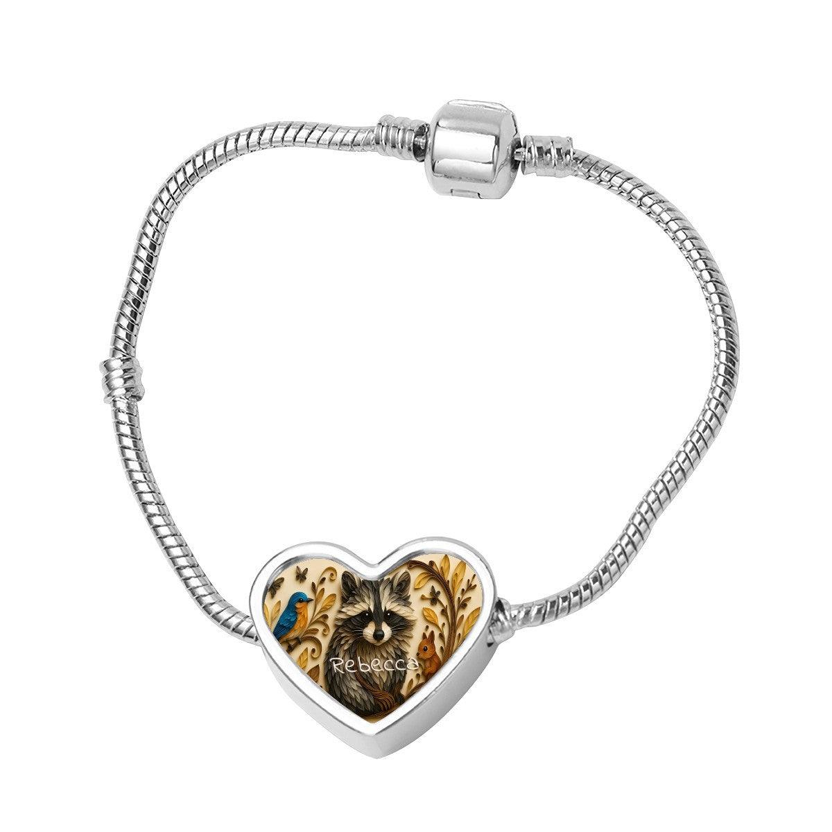 Silver snake chain bracelet with heart-shaped pendant featuring raccoon artwork and name Rebecca
