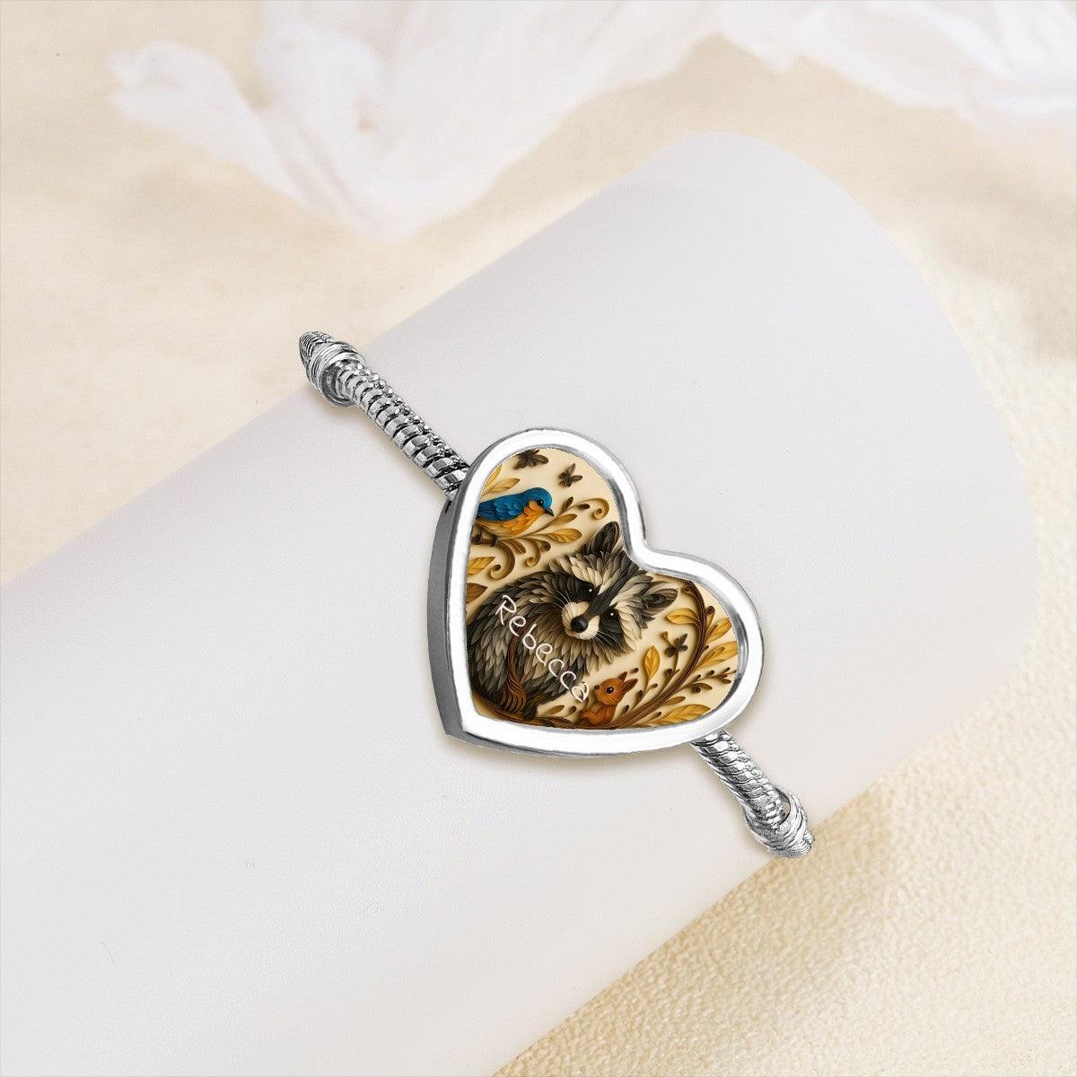 Heart charm bracelet with silver snake chain and raccoon artwork, name Rebecca on the pendant