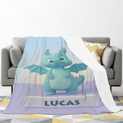 Kids blanket with blue dragon graphic and “LUCAS” text, draped over couch