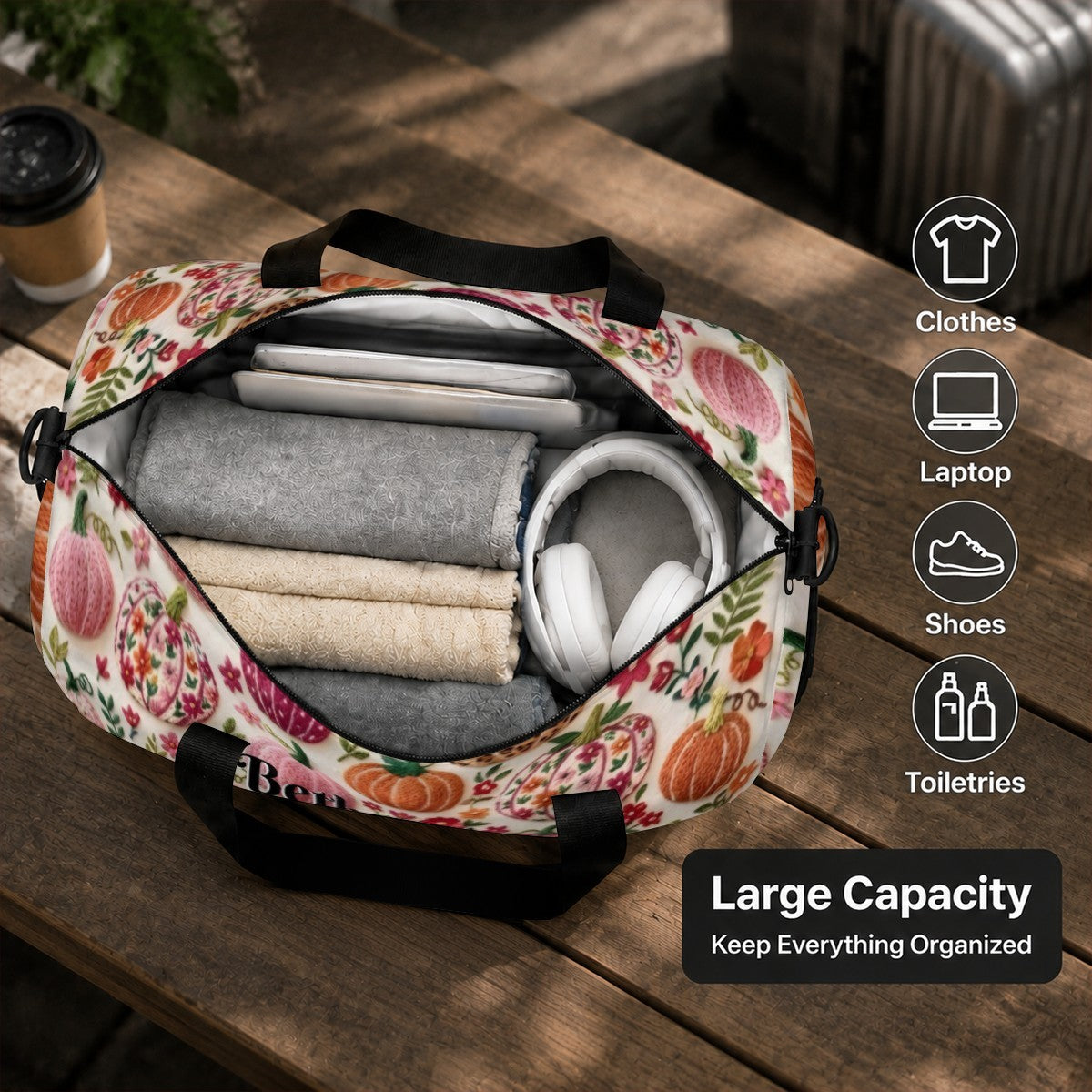 Opened fruit-pattern duffel bag with folded contents inside and black handles
