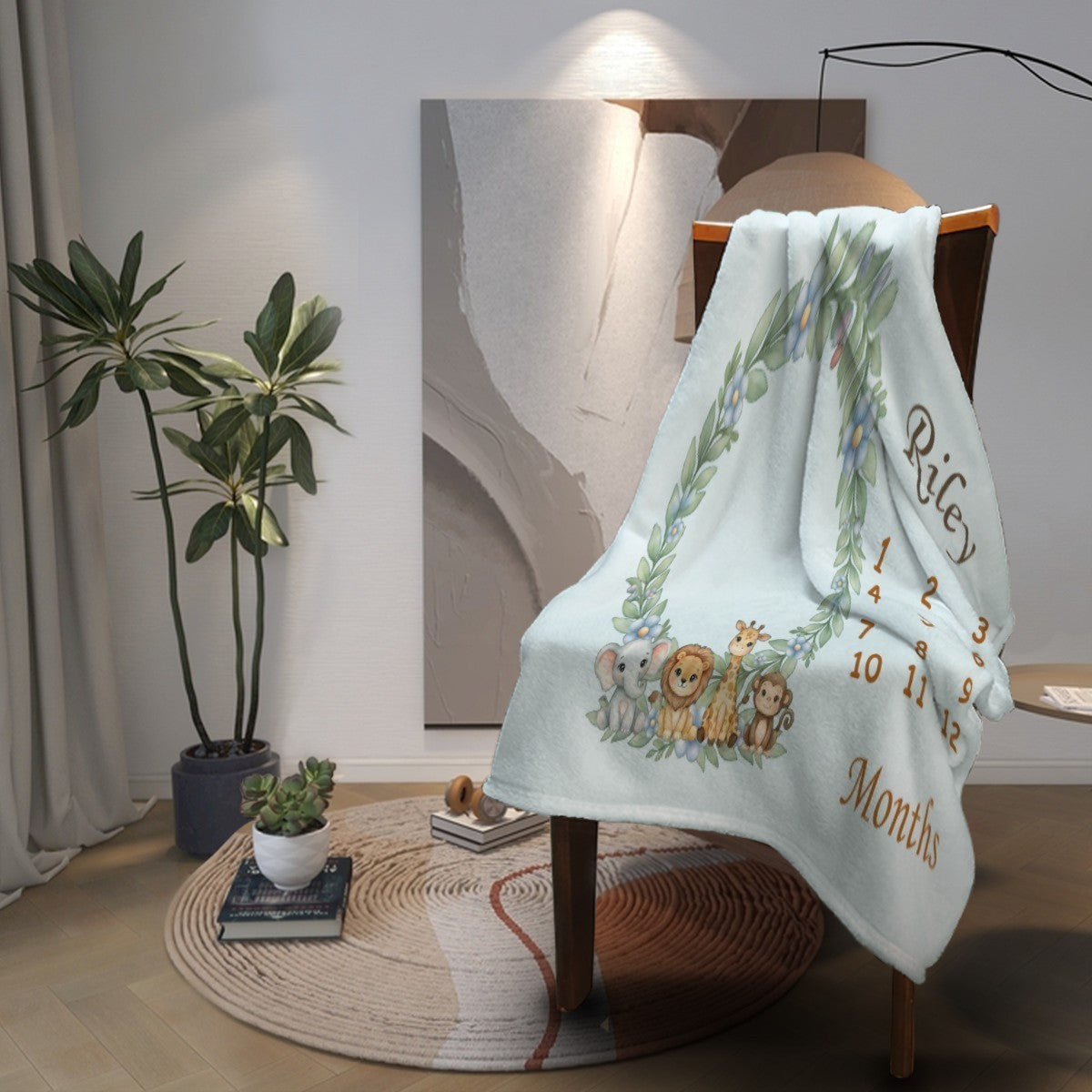 Light blue baby milestone blanket draped over a chair with animal wreath and “Months”