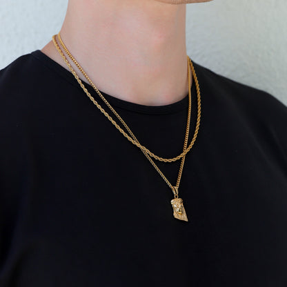 Gold layered chain necklace with Jesus face pendant charm at center