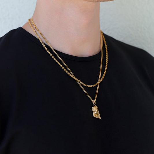 Gold layered chain necklace with Jesus face pendant charm at center