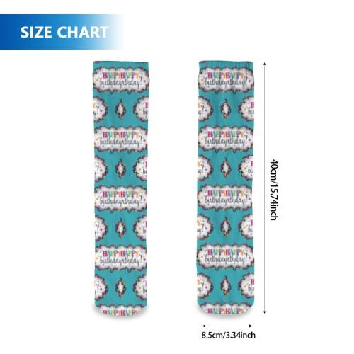 Teal birthday socks with repeating cake pattern, displayed flat with size measurement