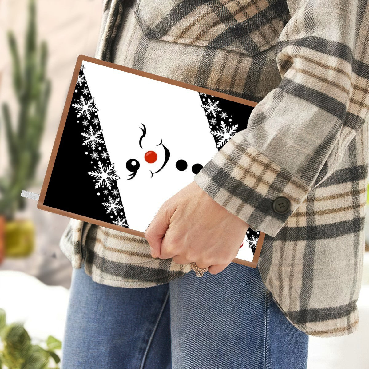 Hand holding snowman A5 notebook with snowflake scarf design and custom name Elena