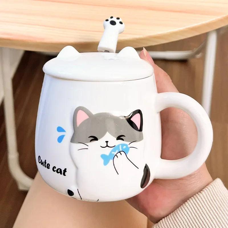 White cat face mug with lid, held in a hand