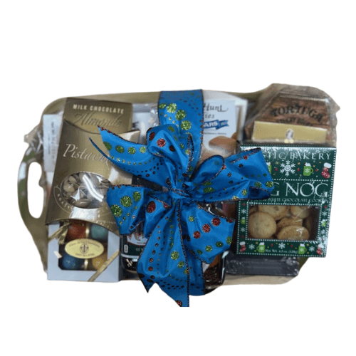 Wrapped gift tray contents with blue bow, chocolates, and holiday cookies