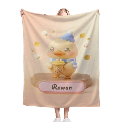 Duck character blanket in light beige with blue hat, yellow flowers, and name banner