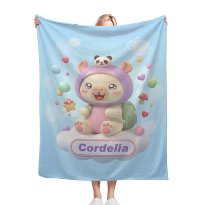 Light blue cartoon blanket with bear character and “Cordelia” design