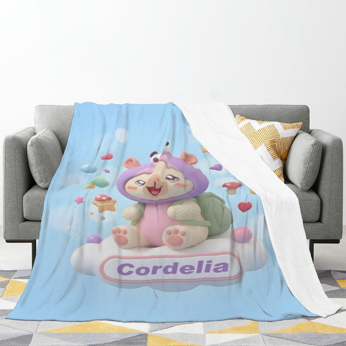 Light blue cartoon blanket with bear character, draped over sofa