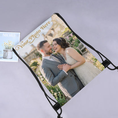 Black drawstring photo bag with custom couple image on a tilted panel and braided drawstrings