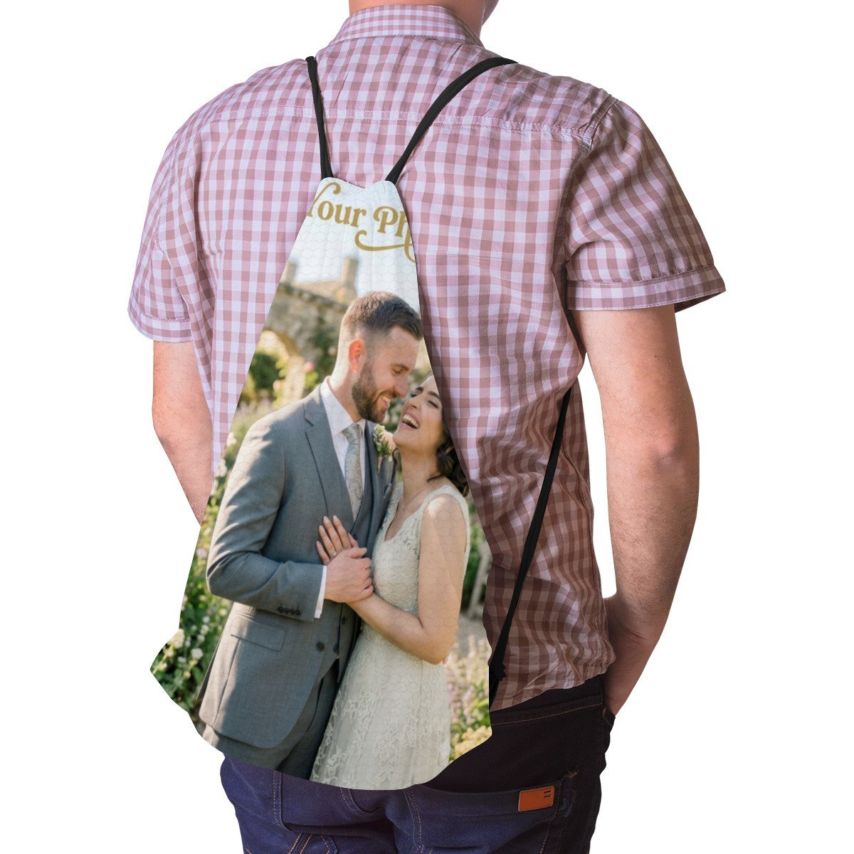 Black drawstring photo bag worn on a person’s back, showing a couple image panel
