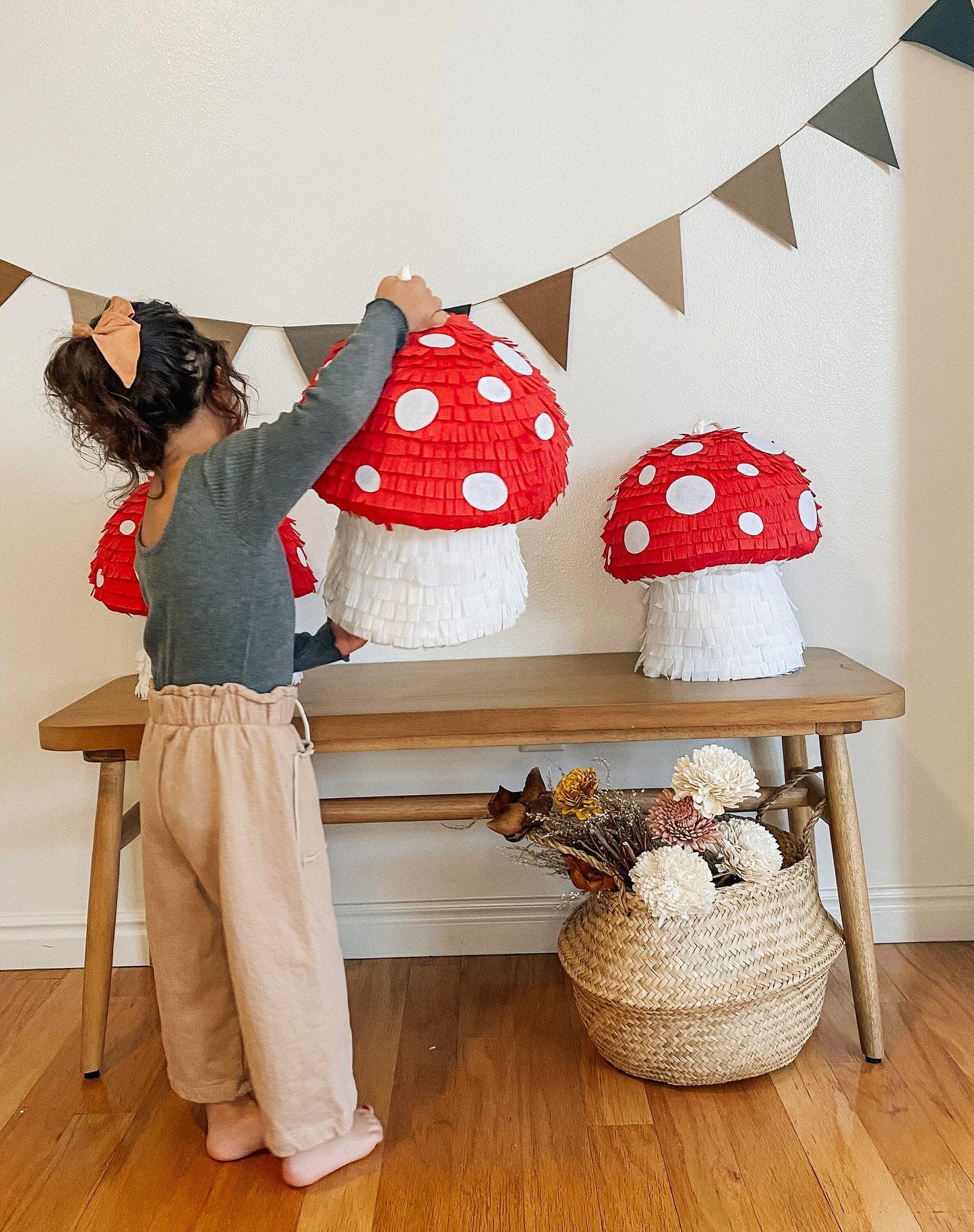 Red mushroom piñata with white spots; layered paper cap and white stem