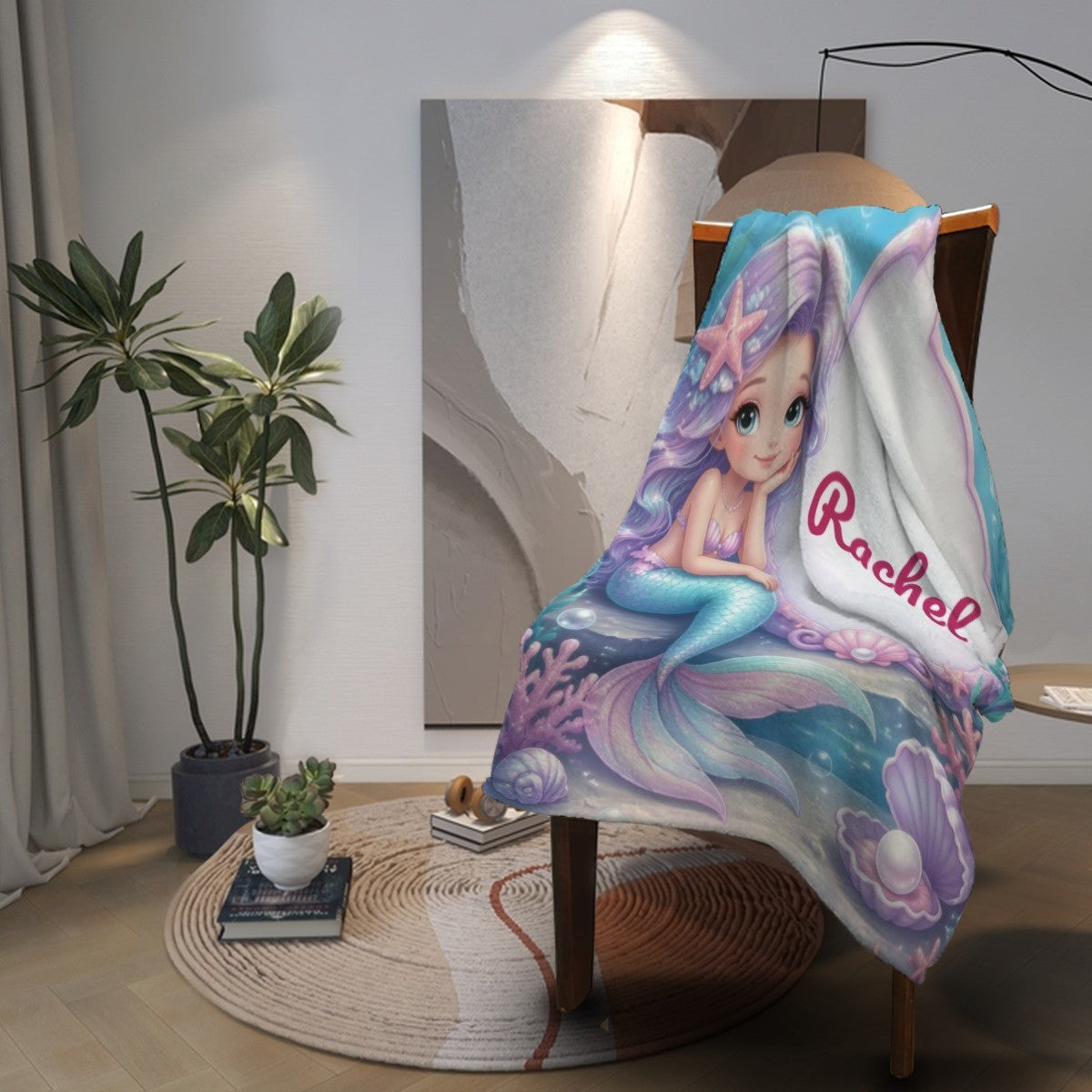 Mermaid blanket throw draped on a chair, featuring “Rachel” and underwater scene