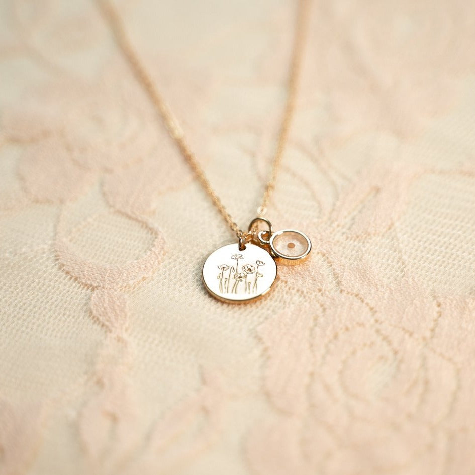 Gold-tone poppy necklace with round engraved pendant and seed charm