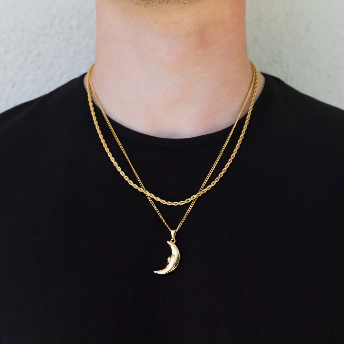 Gold crescent moon pendant necklace with layered chains and moon charm