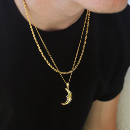 Gold crescent moon pendant necklace with layered chain and hanging charm