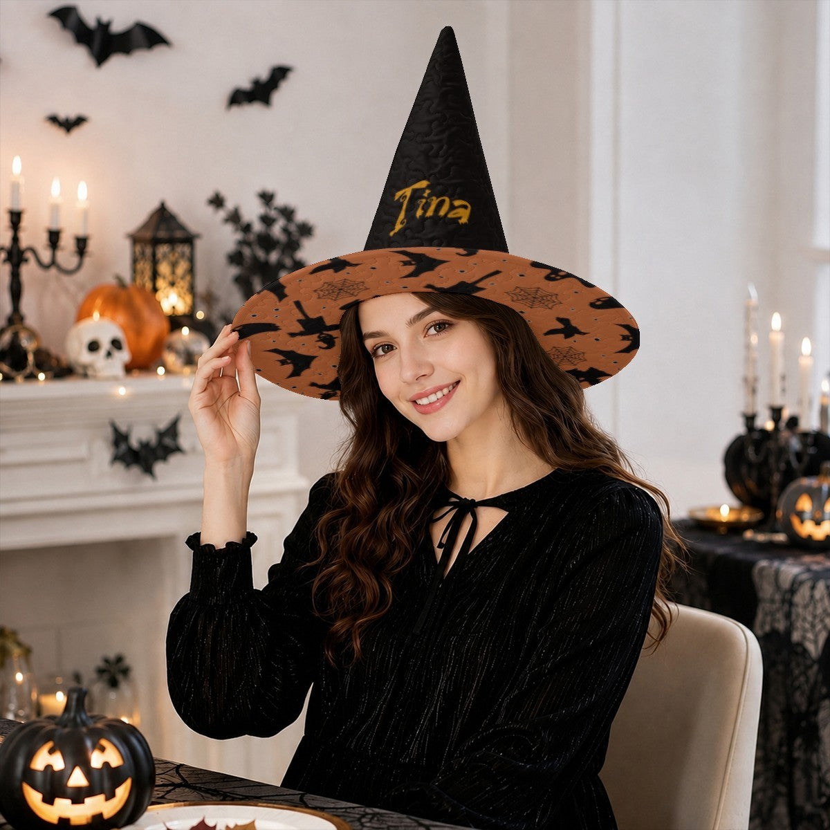 Black witch hat with wide orange patterned brim and custom name on front.