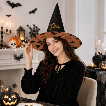 Black witch hat with wide orange patterned brim and custom name on front.