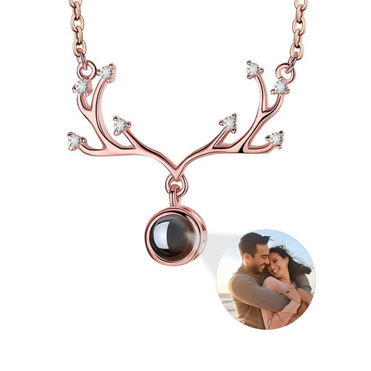 Rose gold antler projection necklace with round photo locket and small crystal accents