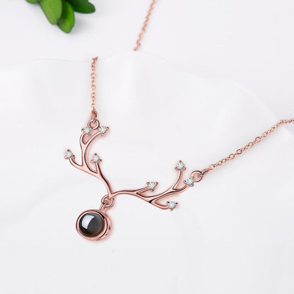 Rose gold antler pendant necklace with round projection locket on a fine chain