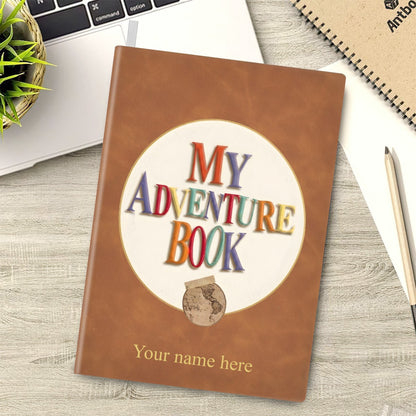 Brown faux-leather adventure notebook with “My Adventure Book” emblem and name line