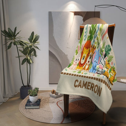 Safari animal blanket folded over chair with CAMERON name on the bottom edge