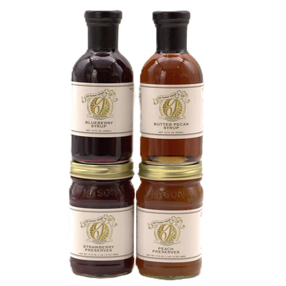 Four fruit preserve jars with dark and amber contents, stacked two by two
