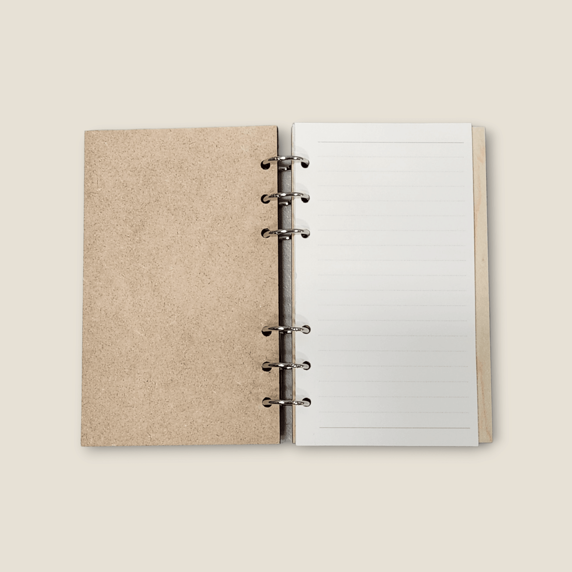 Wood refillable notebook open with blank lined pages and metal binder rings