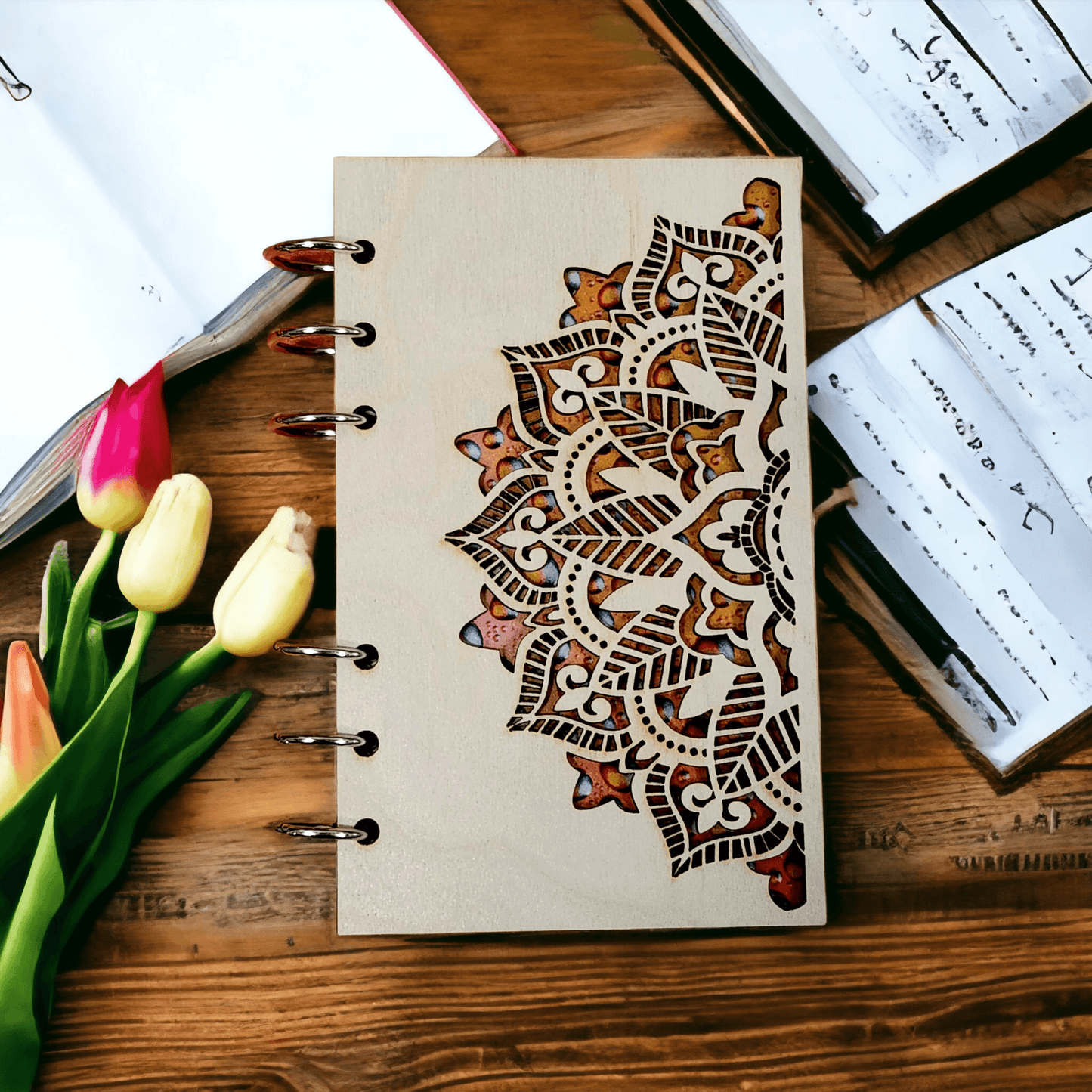 A6 mandala notebook with wood cover, metal rings, and brown ornamental design