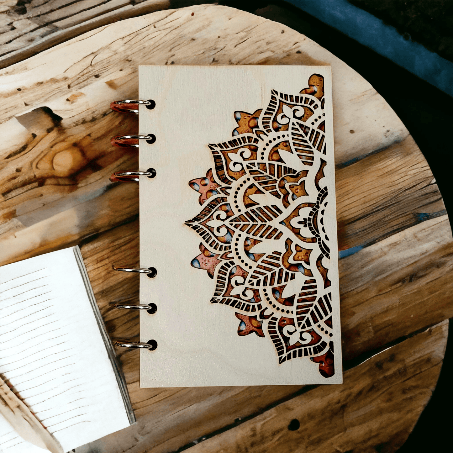 A6 mandala notebook with wood cover, metal rings, and brown ornamental artwork