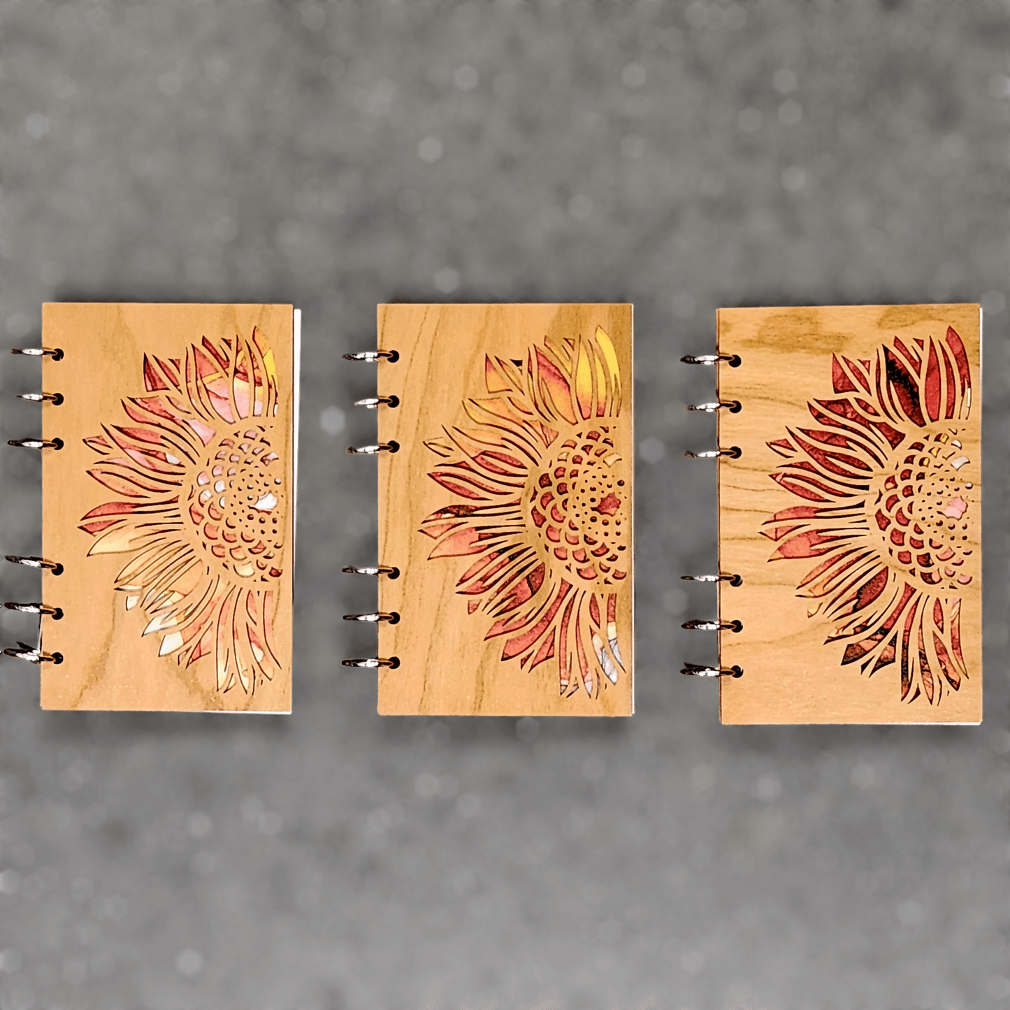 Wood journal notebooks with sunflower laser-cut covers, metal ring binder shown