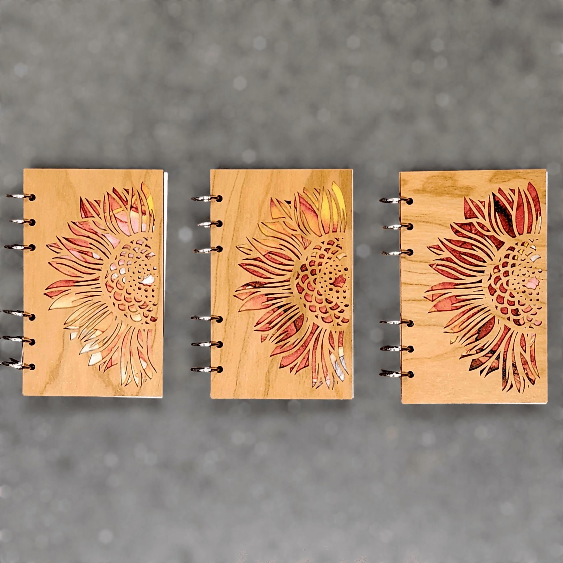 Wood journal notebooks with sunflower laser-cut covers, metal ring binder shown