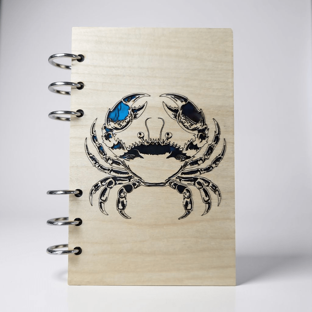 A6 refillable notebook front cover with blue-and-black crab design and metal rings