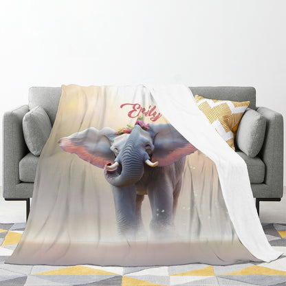 Personalized elephant blanket draped on sofa with 'Emily' name and blue elephant print