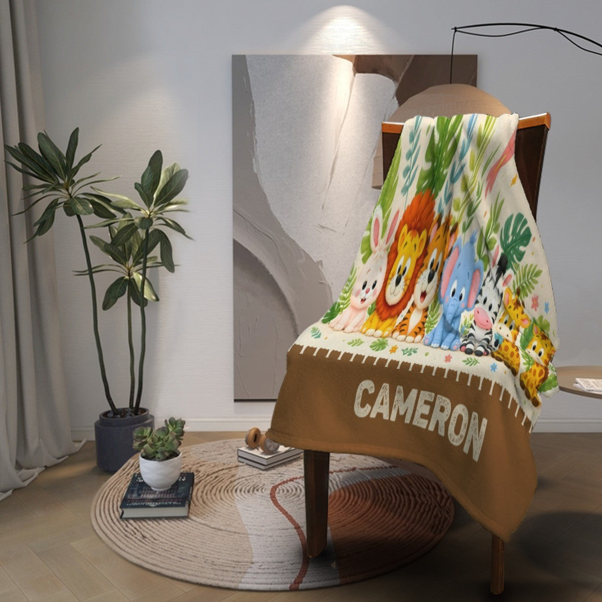 Personalized safari name blanket draped over chair with animal print and CAMERON lettering on brown hem