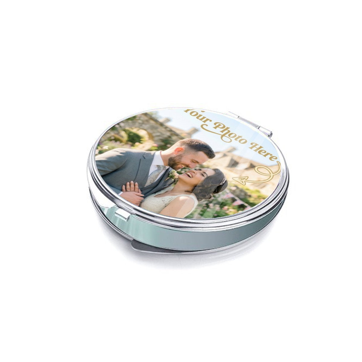 Silver photo compact mirror shown closed from a low angle