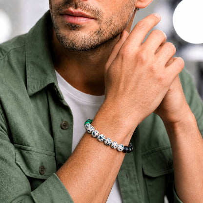Gemstone beaded bracelet on wrist: green malachite, black obsidian, white dalmatian jasper beads