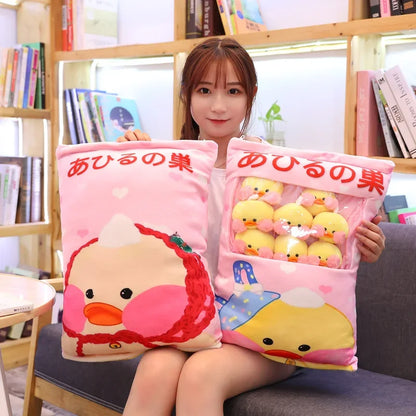 Two pink duck plush pillows with duck face graphics and small stuffed duck plushies
