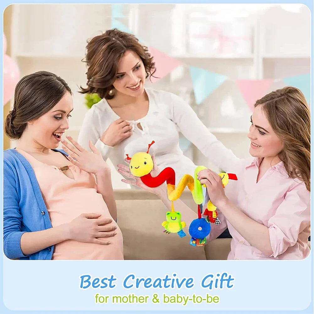 Family with baby while holding a baby spiral hanging activity toy with colorful figures
