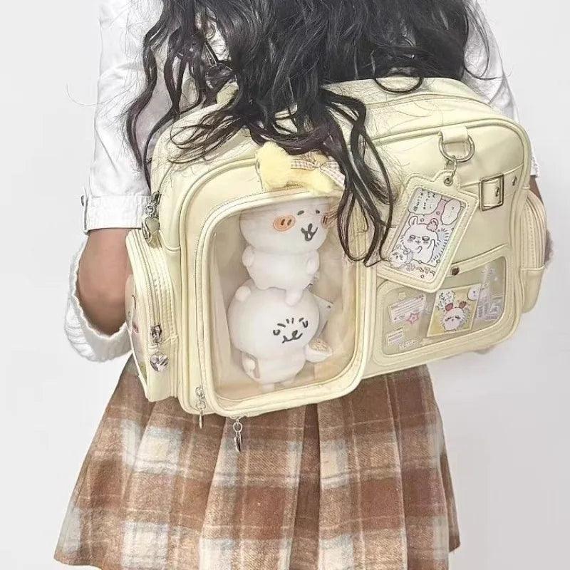 Pastel crossbody bag, light yellow/cream, front clear window pocket with plush toy