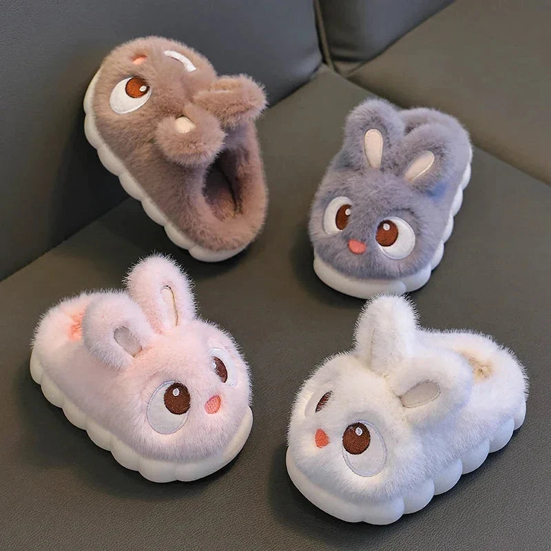 Set of four kids rabbit plush slippers in light gray, brown, and white