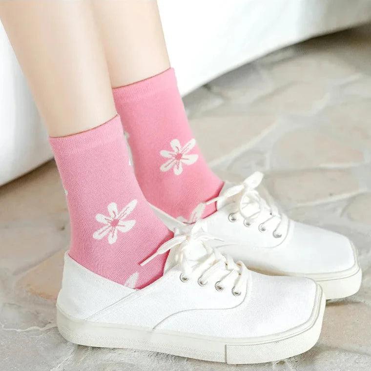 Pair of pink socks with white flower prints
