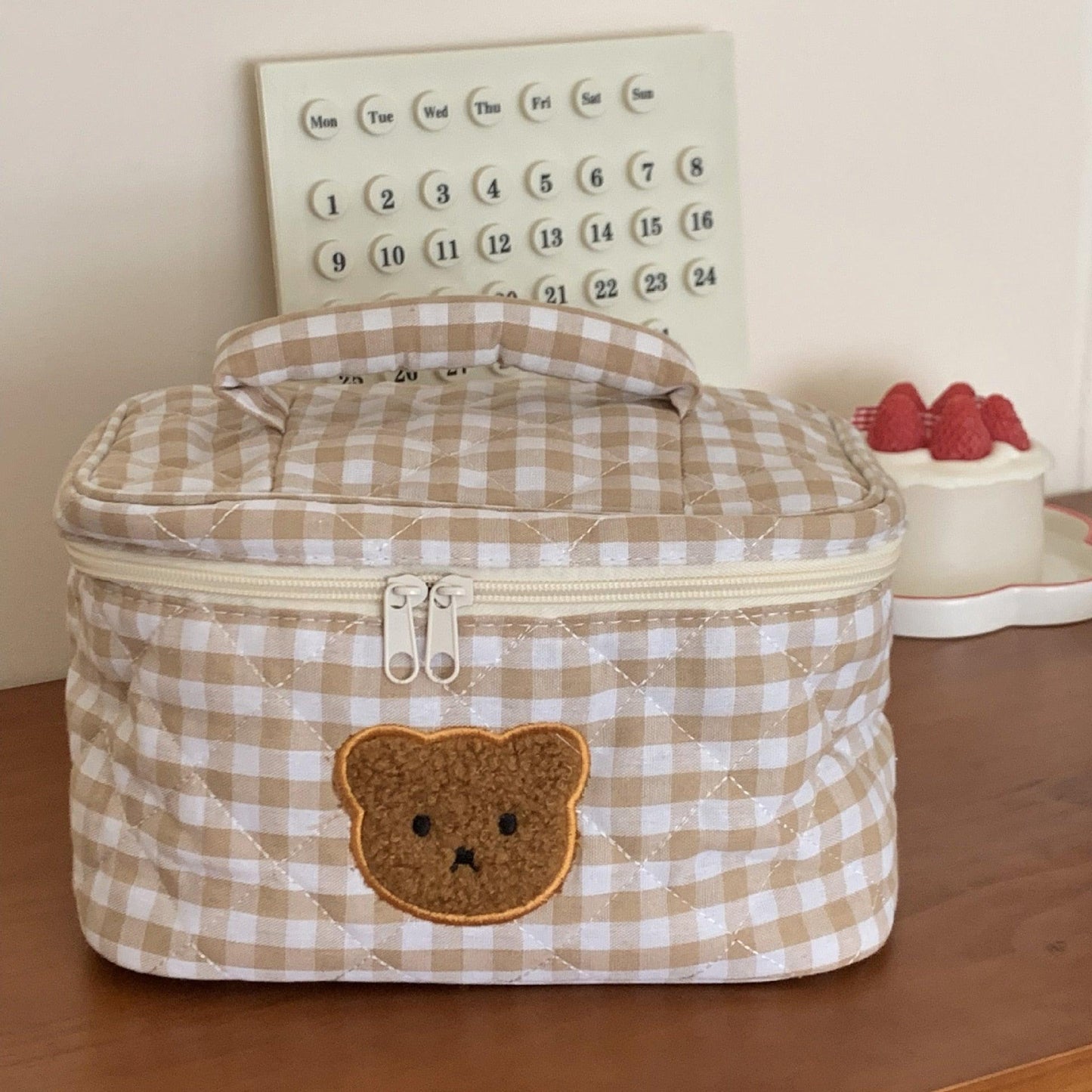 Gingham teddy bear cosmetics bag with front zipper pulls and bear applique