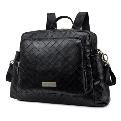 Black quilted diamond diaper backpack with front zip pocket, shoulder and crossbody straps