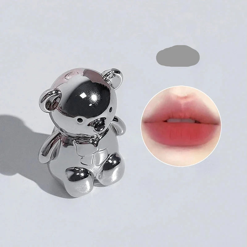 Silver bear-shaped decorative accessory with inset lip color swatch
