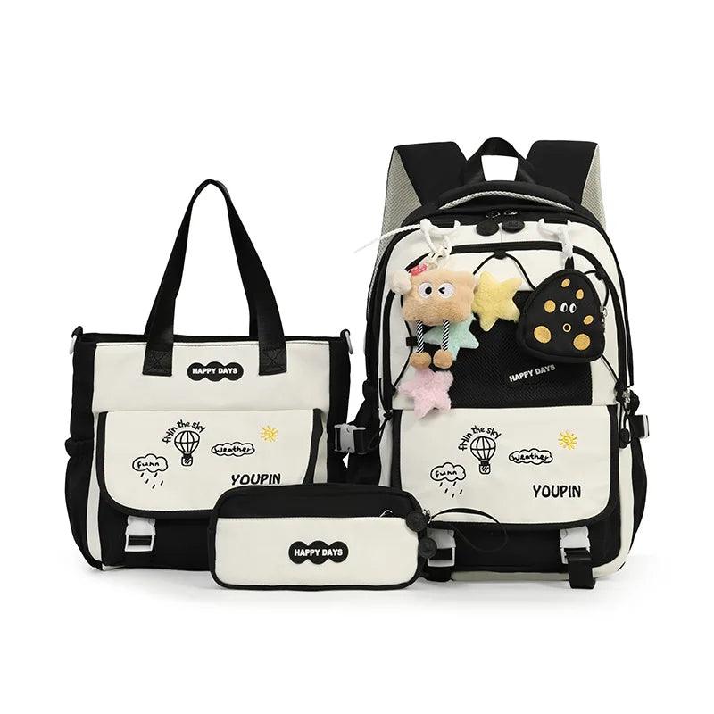 Black kids backpack set with plush charms, front panel pocket, and matching tote bag