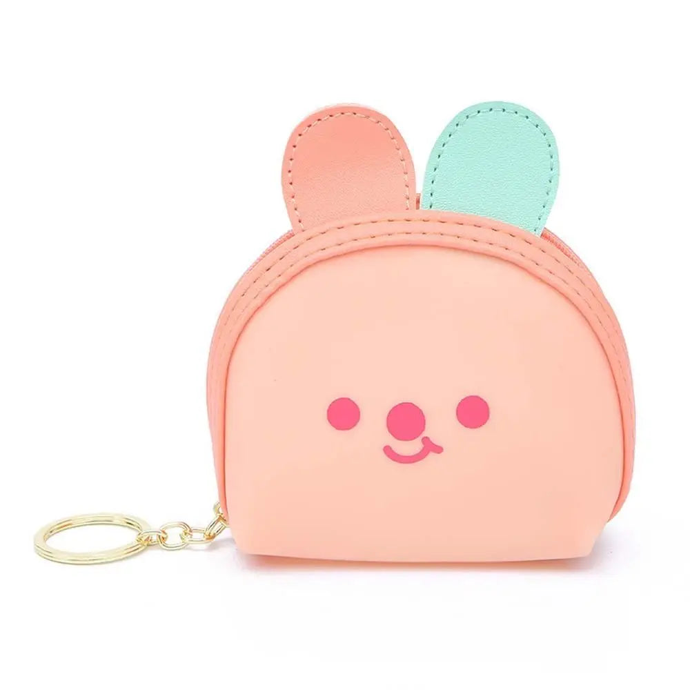 Peach pink bear-face coin purse with teal ear accents and gold key ring