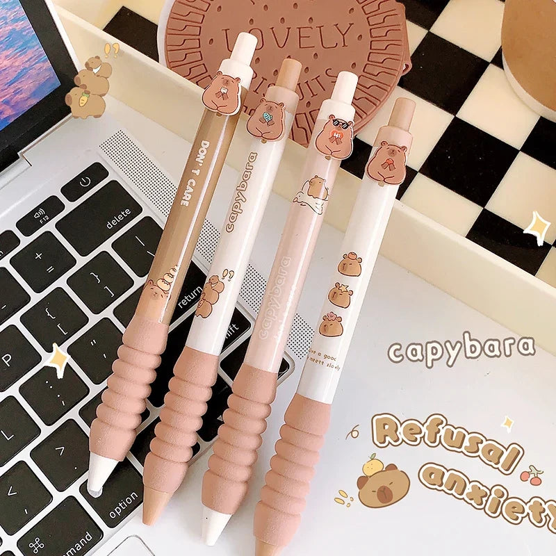 Capybara gel pens on keyboard, light pink and beige barrels with character prints