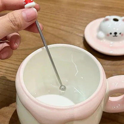 Ceramic cat pudding mug opening with spoon over the smooth white interior
